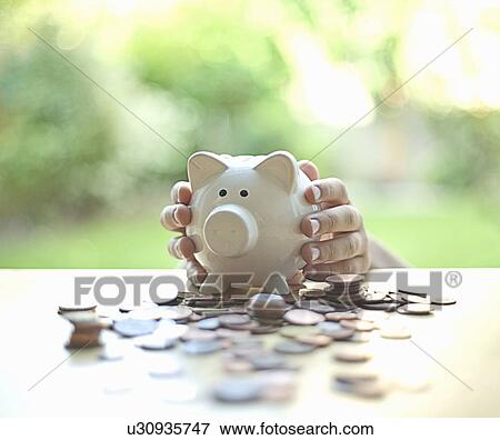 Hands holding piggy bank View Large Photo Image Stock Photo - Hands holding piggy bank. Fotosearch