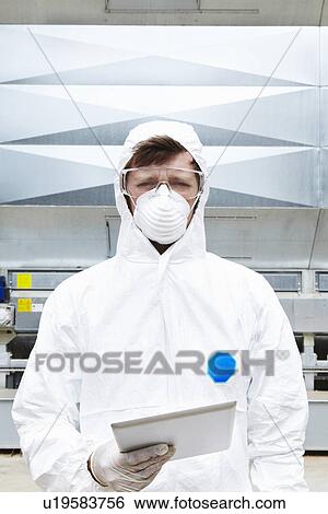Lab worker wearing hazmat suit View Large Photo Image Stock Photograph - Lab worker wearing hazmat suit. Fotosearch