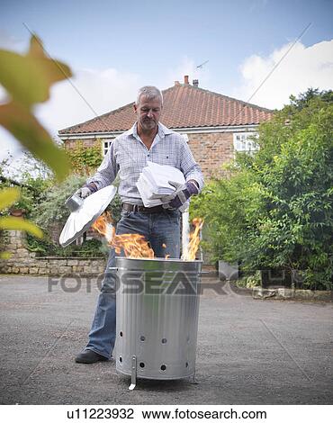 Man burning papers in garbage can View Large Photo Image Stock Image - Man burning papers in garbage can. Fotosearch