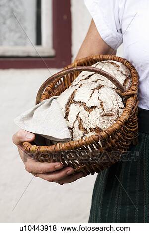 Man holding basket of sourdough bread View Large Photo Image Stock Photo - Man holding basket of sourdough bread. Fotosearch