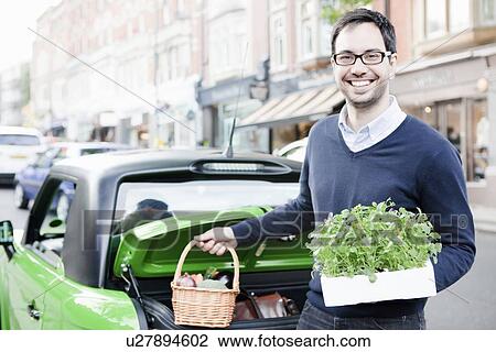 Man loading produce into car View Large Photo Image Stock Image - Man loading produce into car. Fotosearch