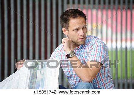Man reading newspaper outdoors View Large Photo Image Stock Image - Man reading newspaper outdoors. Fotosearch