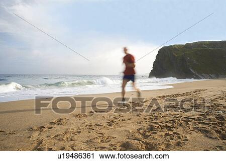 Man running on beach View Large Photo Image Stock Image - Man running on beach. Fotosearch