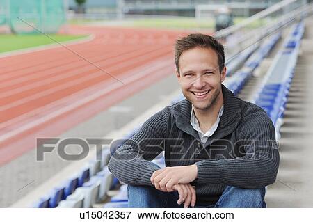 Man sitting in empty bleachers View Large Photo Image Stock Photo - Man sitting in empty bleachers. Fotosearch