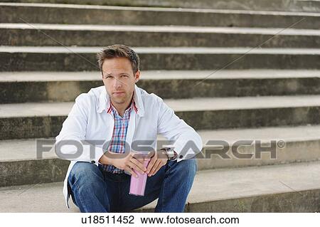 Man sitting on city steps View Large Photo Image Stock Image - Man sitting on city steps. Fotosearch