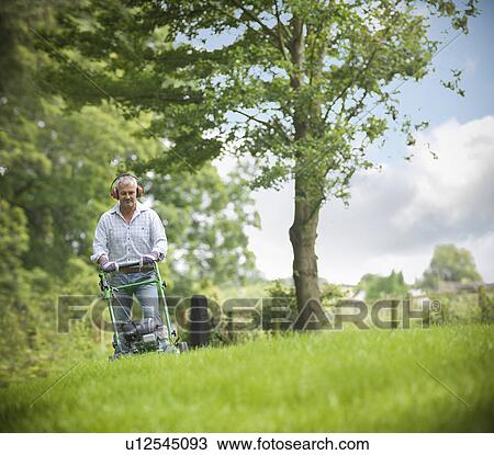 Man wearing headphones and mowing lawn View Large Photo Image Stock Image - Man wearing headphones and mowing lawn. Fotosearch