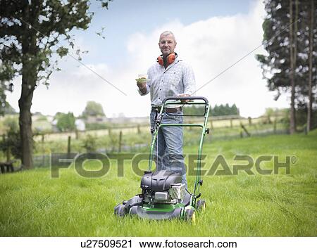 Man with lawn mower having cup of tea View Large Photo Image Stock Image - Man with lawn mower having cup of tea. Fotosearch