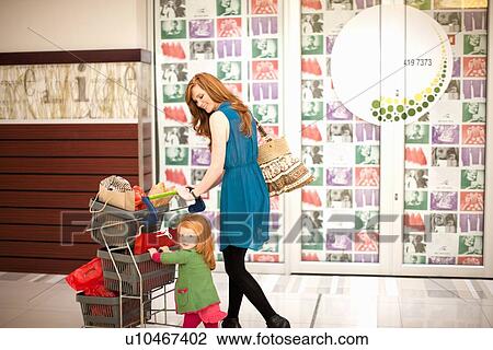 Mother and daughter shopping in mall View Large Photo Image Stock Image - Mother and daughter shopping in mall. Fotosearch