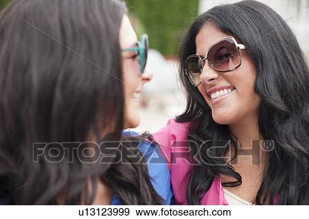 Stock Photo - Mother and daughter smiling together. Fotosearch