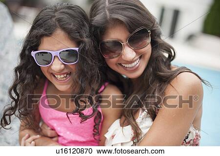 Stock Image - Mother and daughter wearing sunglasses. Fotosearch