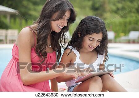 Stock Image - Mother and daughter with tablet computer. Fotosearch