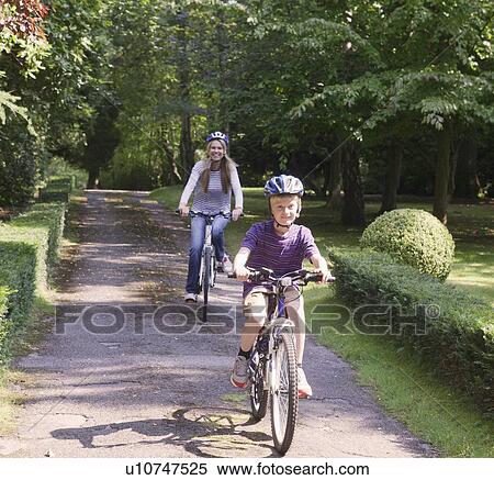 Mother and son riding bicycles together View Large Photo Image Stock Photography - Mother and son riding bicycles together. Fotosearch
