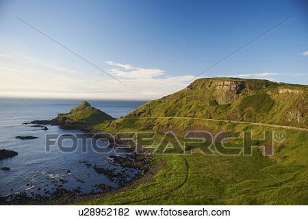 Stock Image - Paved road on rural hillside. Fotosearch