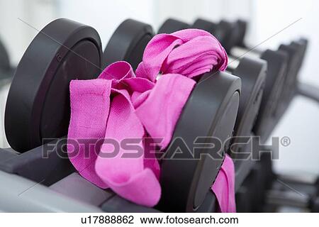 Stock Image - Pink boxing bandages on weights in gym. Fotosearch