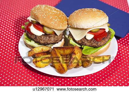 Plate of burgers and potatoes View Large Photo Image Stock Image - Plate of burgers and potatoes. Fotosearch