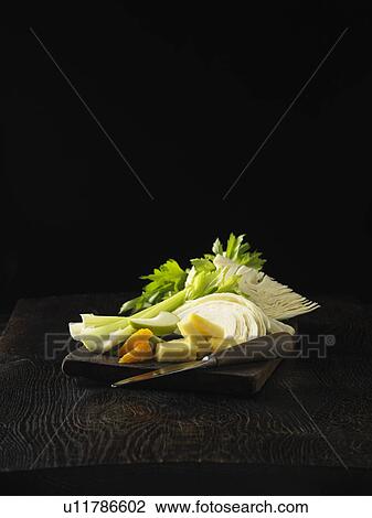 Stock Image - Plate of celery, orange, and cabbage. Fotosearch