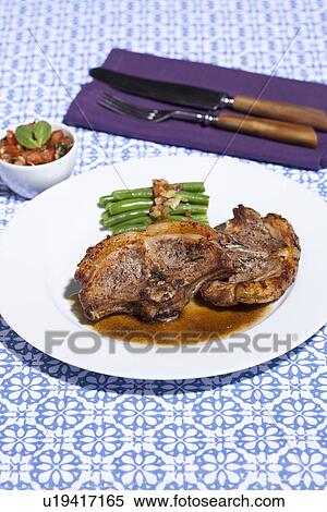 Stock Photography - Plate of lamb chops and asparagus. Fotosearch