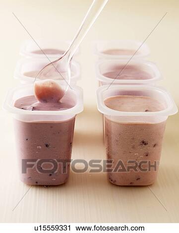 Stock Image - Pots of strawberry and raspberry yogurt. Fotosearch