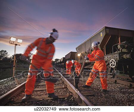 Stock Photo - Railway worker adjusting train tracks. Fotosearch