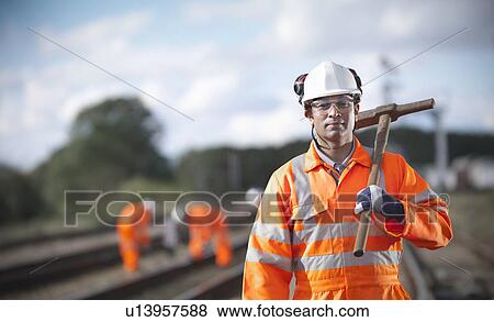 Railway worker carrying sledgehammer View Large Photo Image Stock Photo - Railway worker carrying sledgehammer. Fotosearch