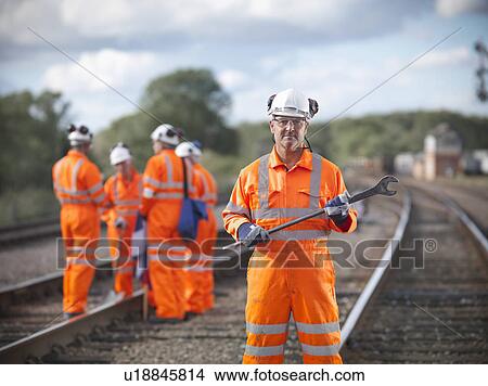 Railway worker carrying wrench View Large Photo Image Picture - Railway worker carrying wrench. Fotosearch
