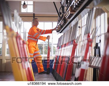 Railway worker pulling track lever View Large Photo Image Picture - Railway worker pulling track lever. Fotosearch