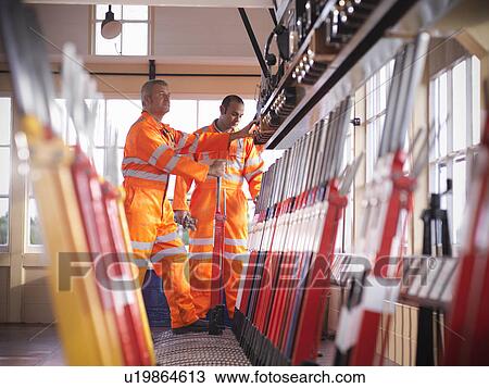 Railway worker pulling track lever View Large Photo Image Stock Image - Railway worker pulling track lever. Fotosearch