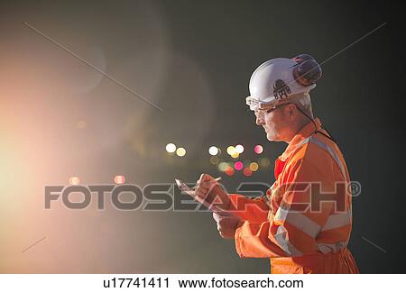 Railway worker writing on clipboard View Large Photo Image Stock Image - Railway worker writing on clipboard. Fotosearch