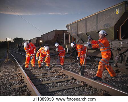 Railway workers adjusting train tracks View Large Photo Image Stock Image - Railway workers adjusting train tracks. Fotosearch