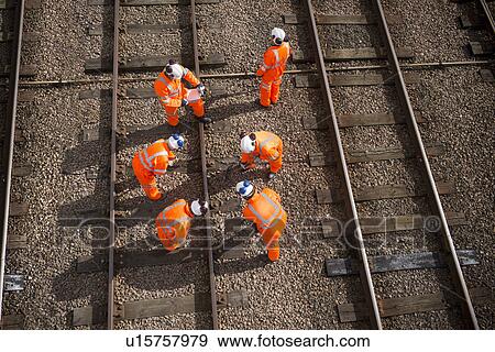 Stock Photo - Railway workers examining train tracks. Fotosearch