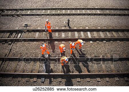 Railway workers examining train tracks View Large Photo Image Stock Photography - Railway workers examining train tracks. Fotosearch