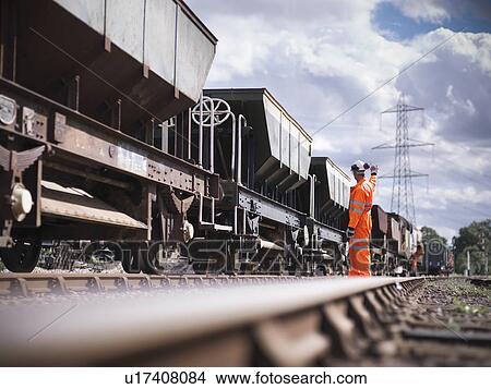 Railway workers signaling train View Large Photo Image Picture - Railway workers signaling train. Fotosearch