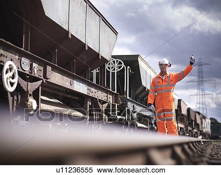 Railway workers signaling train View Large Photo Image Stock Photography - Railway workers signaling train. Fotosearch