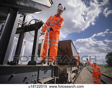 Railway workers standing on train View Large Photo Image Stock Photography - Railway workers standing on train. Fotosearch