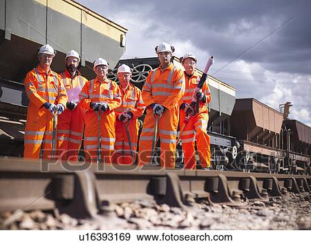 Railway workers standing on train tracks View Large Photo Image Stock Photo - Railway workers standing on train tracks. Fotosearch