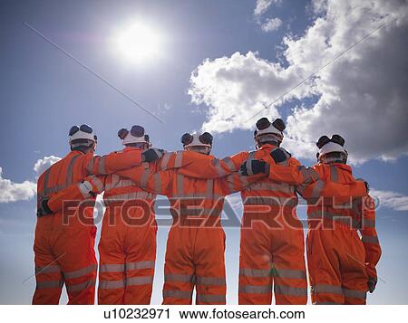 Railway workers standing together View Large Photo Image Stock Image - Railway workers standing together. Fotosearch