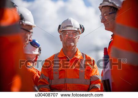 Railway workers talking outdoors View Large Photo Image Stock Photo - Railway workers talking outdoors. Fotosearch