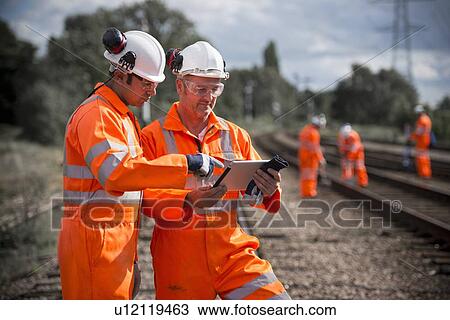 Railway workers using tablet computer View Large Photo Image Stock Image - Railway workers using tablet computer. Fotosearch