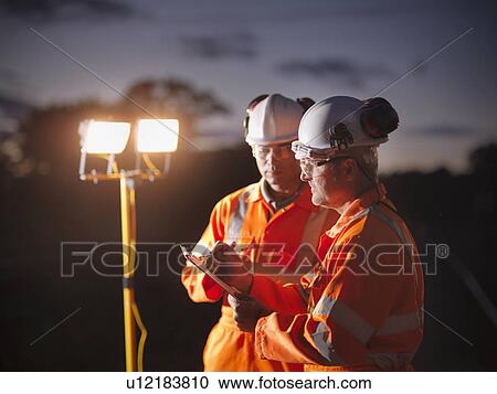 Railway workers writing on clipboard View Large Photo Image Stock Image - Railway workers writing on clipboard. Fotosearch