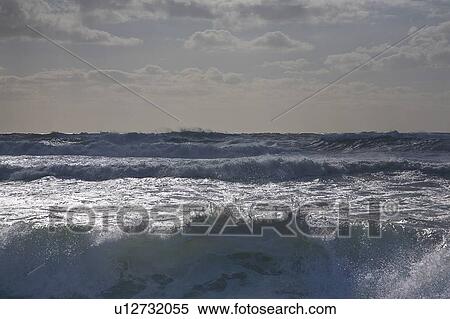 Stock Photography - Rocky waves crashing on beach. Fotosearch