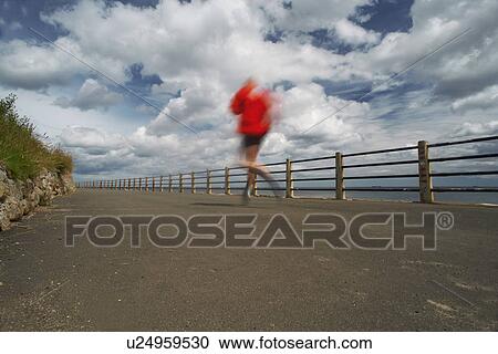 Runner on paved coastal road View Large Photo Image Stock Image - Runner on paved coastal road. Fotosearch