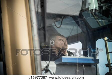Sailors steering boat View Large Photo Image Stock Photo - Sailors steering boat. Fotosearch