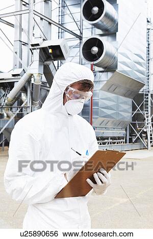 Scientist writing on clipboard View Large Photo Image Stock Photograph - Scientist writing on clipboard. Fotosearch