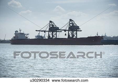 Silhouette of container ship and cranes View Large Photo Image Picture - Silhouette of container ship and cranes. Fotosearch