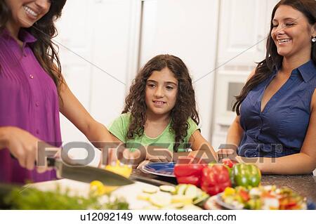 Sisters cooking together in kitchen View Large Photo Image Stock Photo - Sisters cooking together in kitchen. Fotosearch