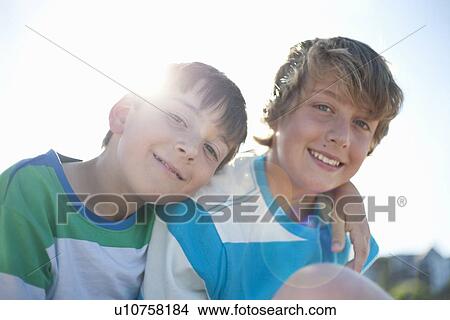 Smiling brothers hugging outdoors View Large Photo Image Picture - Smiling brothers hugging outdoors. Fotosearch