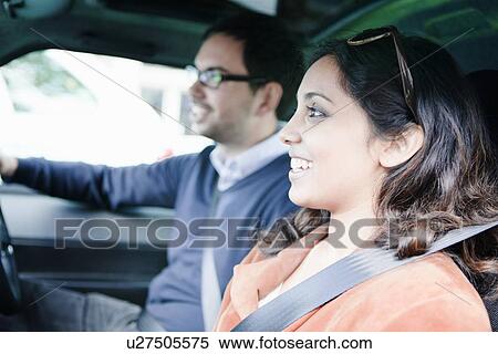 Stock Photography - Smiling couple riding in car. Fotosearch