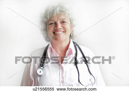 Stock Photography - Smiling doctor wearing stethoscope. Fotosearch