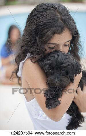 Smiling girl holding puppy View Large Photo Image Picture - Smiling girl holding puppy. Fotosearch