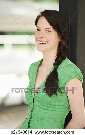Smiling woman leaning against doorway View Large Photo Image Picture - Smiling woman leaning against doorway. Fotosearch